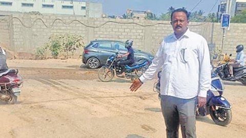 Advocate Raveesh shows the encroached SWD which is cut and concreted at Thubarahalli near Vibghyor School