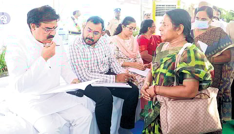 Civil Supplies Minister Nadendla Manohar receiving grievances from public at the PGRS programme held in Kollipara on Monday.