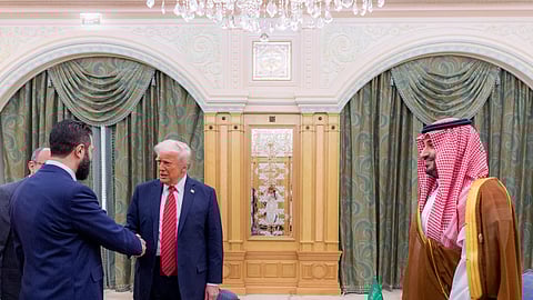 In this file image, Saudi Crown Prince Mohammed bin Salman (R) looks on as US President Donald Trump (C) shakes hands with Syria’s interim president Ahmed al-Sharaa in Riyadh.