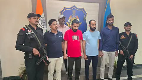 Members of the Gujarat ATS with the arrested Bangladeshi and his associates.
