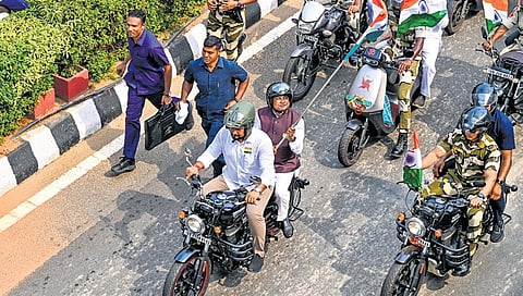 CM Mohan Charan Majhi riding pillion on the motorbike driven by Higher Edu min Suryabanshi Suraj, during the motorcycle rally on Wednesday.