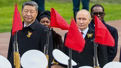 Chinese President Xi Jinping, left, Russian President Vladimir Putin attend a wreath laying ceremony at the Tomb of the Unknown Soldier in Alexander Garden after the Victory Day military parade in Moscow, Russia, Friday, May 9, 2025.