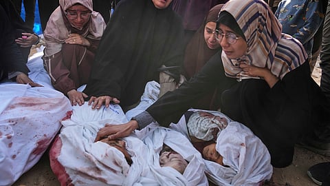 Palestinians mourn children from their families who were killed in Israeli airstrikes in Jabalia, in the northern Gaza Strip, on Wednesday, May 14, 2025.