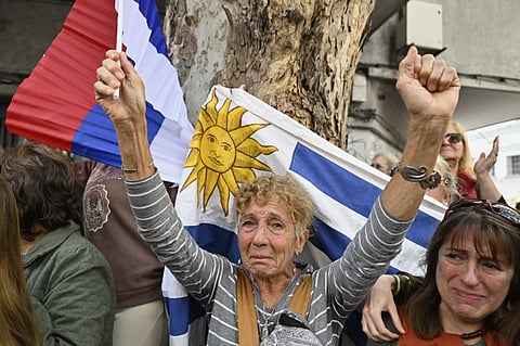 Mourners watch the casket of Uruguay’s former President Jose Mujica from the sidelines of his funeral procession from the presidential palace to the National Assembly in Montevideo, Uruguay, Wednesday, May 14, 2025.