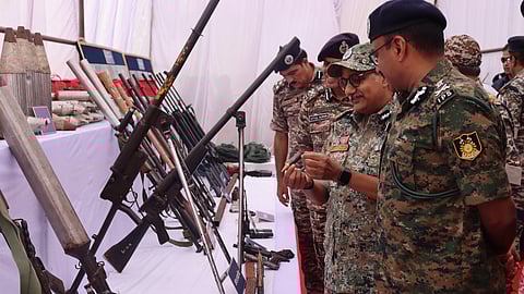 CRPF DG and Chhattisgarh DGP examine weapons recovered from Maoists.