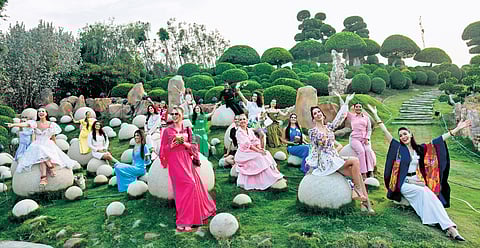 Miss World contestants pose on the rocks at the Experium Eco Park in Hyderabad on Friday