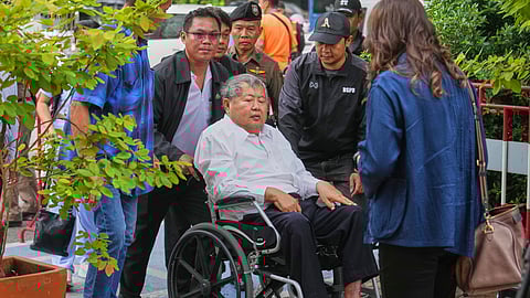 Premchai Karnasuta, the president of Italian-Thai Development Co., arrives on a wheelchair at Bang Sue Police Station in Bangkok, Thailand, Friday, May 16, 2025, to surrender to police on criminal negligence charges for the collapse of a Bangkok high-rise during a March 28 earthquake.