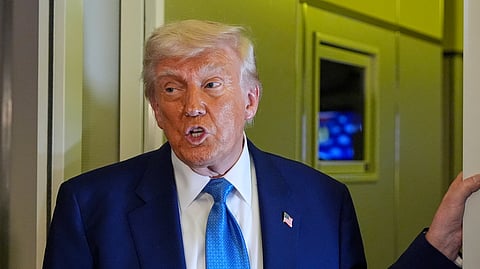 US President Donald Trump speaks on Air Force One at Abu Dhabi International Airport before departing, Friday, May 16, 2025, in Abu Dhabi, United Arab Emirates.