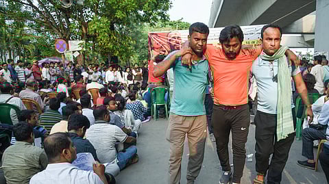 Teachers and non-teaching staff stage a sit-in protest against police lathi-charge on protesters on May 15 in front of Bikash Bhawan during a protest against the Supreme Court's upholding a Calcutta HC order to cancel appointments of over 25,000 staff in West Bengal schools by SSC in front of Bikash Bhawan, in Kolkata on Friday.