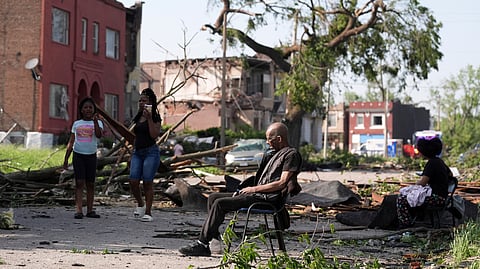 A man sits in a chair after a severe storm moved through St. Louis, Missouri, Friday, May 16, 2025.