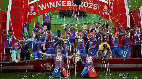 Marc Guehi and Joel Ward of Crystal Palace lift the FA Cup trophy after their team’s victory in the Emirates FA Cup Final match between Crystal Palace and Manchester City at Wembley Stadium on May 17, 2025 in London, England.