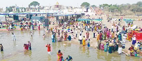 Pilgrims take a holy dip on the fourth day of the Saraswati Pushkaralu in Kaleshwaram.