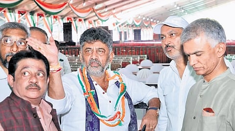 Deputy Chief Minister DK Shivakumar oversees arrangements for the state government’s Sadhana Samavesha, as cabinet colleagues BZ Zameer Ahmed Khan and Krishna Byre Gowda look on, in Hosapete on Monday