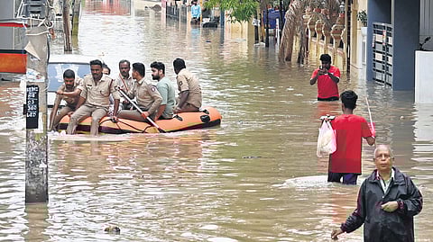 Residents of Sai Layout in Bengaluru being evacuated on a dingy following heavy rain on Monday. Housekeeping staffer Shashikala