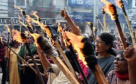 Anganwadi workers hold a torchlight march in front of the Vellore district collectorate on Friday evening, raising some of their long-pending demands, including regularisation and pension benefits.