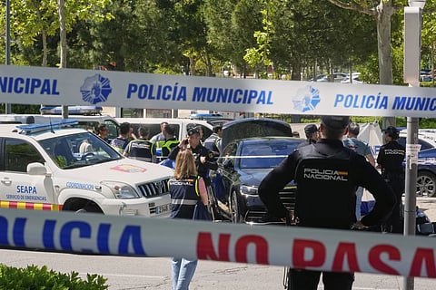 Police officers cordon off the area after an adviser to former Ukrainian president Viktor Yanukovych was shot, outside a school in Madrid, Spain, Wednesday, May 21, 2025.