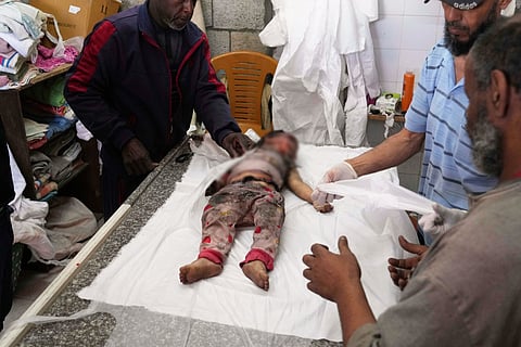 The body of 2-year-old Farah Al Baz, a Palestinian child killed in an Israeli army airstrike that struck her family's home, is brought to Al-Aqsa Hospital in Deir al-Balah, Gaza, on Wednesday, May 21, 2025.