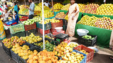 A woman vendor selling fresh mangoes at fruit market in Tirupati on Wednesday.