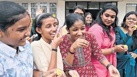 Students of Carmel Girls HSS, Thiruvananthapuram, share sweets in celebration after the announcement of their Plus-II examination results on Thursday