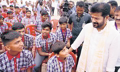 Chief Minister A Revanth Reddy interacts with students after the inauguration of a Kendriya Vidyalaya at Machnoor village in Sangareddy district on Friday.