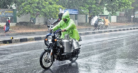 Motorists riding through the rain on the Mettupalayam - Coimbatore highway on Friday. The RMC issues red alert for Nilgiris & ghat areas of Coimbatore on May 25 and 26
