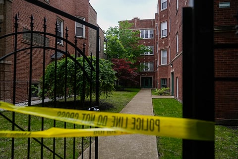 Police tape is tied around a gate outside of a building at an address listed in public records as the home of Elias Rodriguez, who police identified as the suspect in the killing of two staff members of the Israeli Embassy in Washington, Thursday, May 22, 2025, in Chicago.
