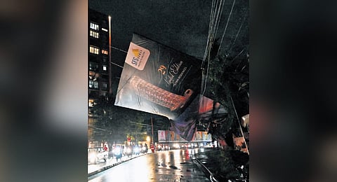 Traffic along the Sasthamangalam- Vartiyoorkavu road was disrupted after a billboard got entangled in power lines following heavy rain in the state capital on Friday night