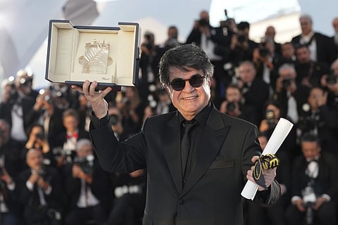 Director Jafar Panahi, winner of the Palme d’Or for he film 'It was Just an Accident,' poses for photographers at the awards ceremony photo call at the 78th international film festival, Cannes, southern France, Saturday, May 24, 2025