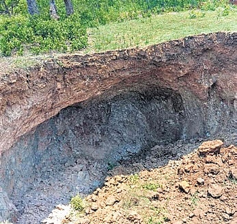 Sources said a minor part of soil overburden caved in at the site, causing a pit.