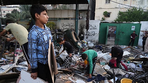Palestinians inspect the damage at a school used as a shelter by displaced residents that was hit by Israeli military strike and killed at least 36 people, in Gaza City, on Monday, May 26, 2025.