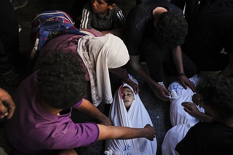 Mourners gather around the body of Palestinian child Ghazwane Hamdan,10, killed in an Israeli army airstrike, and brought to the Baptist Hospital in Gaza City, Monday, May 26, 2025.