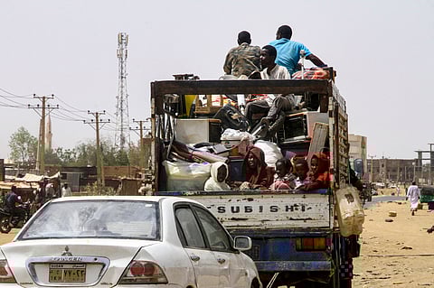 People transport their belongings as they return to Salha, south of Omdurman, two days after the Sudanese army recaptured it from the paramilitary Rapid Support Forces (RSF), on May 22, 2025.