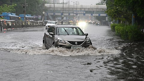 Vehicles ply on a road amid rains near ITO, in New Delhi on Friday, May 2, 2025.