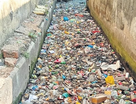 A drain at Kazi Bazar heavily clogged with garbage