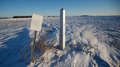 FILE - A border marker, between the United States and Canada is shown just outside of Emerson