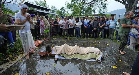 In this photo from May 8, 2025, Sanjeev Barghava (L) performs the last rites of his 13-year-old son, Vihaan Barghava, who was killed in Pakistani artillery shelling in Poonch, along the Line of Control in Kashmir.