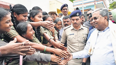 Chief Minister Siddaramaiah welcomes students to the new academic year at Karnataka Public School in Adugodi on Thursday.
