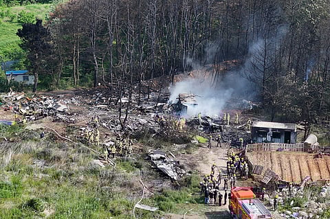 South Korean firefighters and military officers work at the scene of a South Korean navy plane's crash in Pohang, South Korea, Thursday, May 29, 2025.