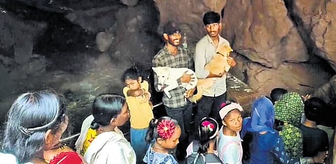 The two youths holding their pets inside Gupteswar temple in Koraput district.