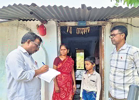 A teacher from ZPHS Mallapur speaks to the family members of a student as part of a door-to-door campaign in Karimnagar district.