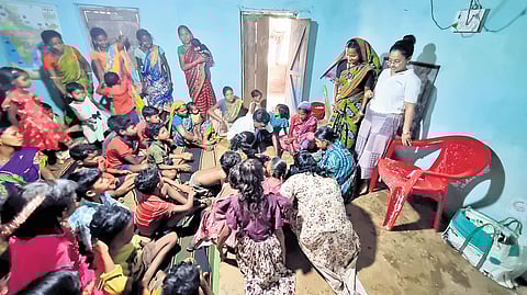 Children and their mothers take part in a fun activity at the community learning centre.