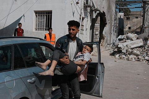 A Palestinian boy, injured following an Israeli airstrike, is brought for treatment to the Baptist Hospital in Gaza City, Friday, May 30, 2025.