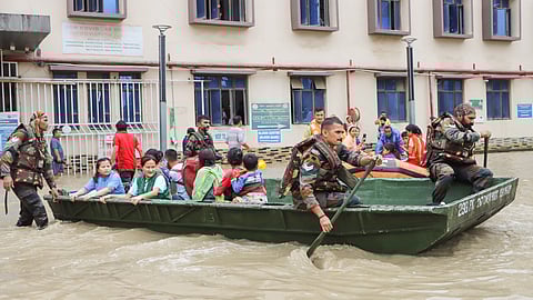 Assam Rifles personnel carry out patient evacuation operation at a flood-affected area Jawaharlal Nehru Institute of Medical Sciences (JNIMS), Porompat in Imphal East on Sunday