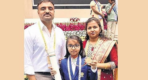 Charvi A with her parents.