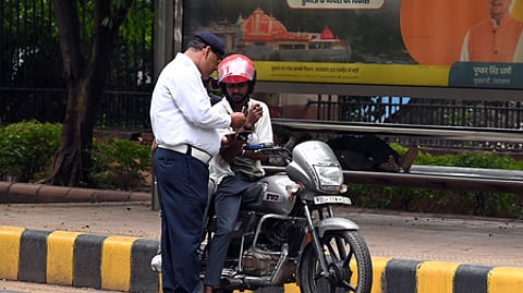 Traffic police conduct checks in New Delhi for insurance papers of vehicles.