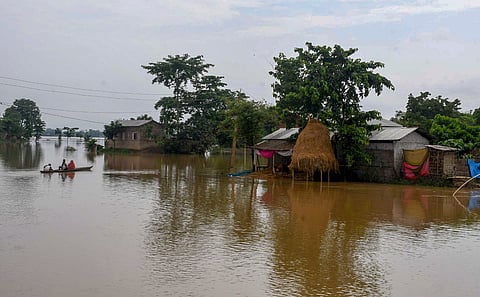 People use a boat to move to safer areas after heavy rainfall triggered floods, in Nagaon district of Assam, Monday, June 2, 2025.