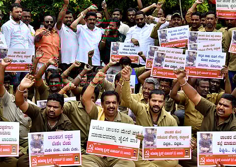 A group of auto drivers protests against a woman assaulting one of the drivers with footwear at Freedom Park in Bengaluru, on Monday
