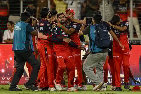 Royal Challengers Bengaluru's players embrace their teammate Virat Kohli after winning their maiden IPL title on Tuesday