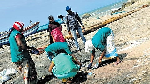 Workers sieve through the sand to separate plastic nurdles; 30 members from MERC Gujarat have been appointed to oversee the cleanup.