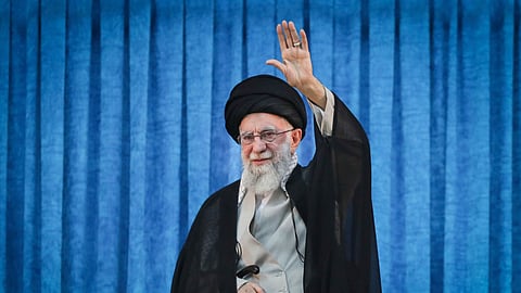 Supreme Leader Ayatollah Ali Khamenei waves to the crowd as he arrives for a ceremony marking the anniversary of the 1989 death of the late revolutionary founder Ayatollah Khomeini at his shrine just outside Tehran, Iran, Wednesday, June 4, 2025.
